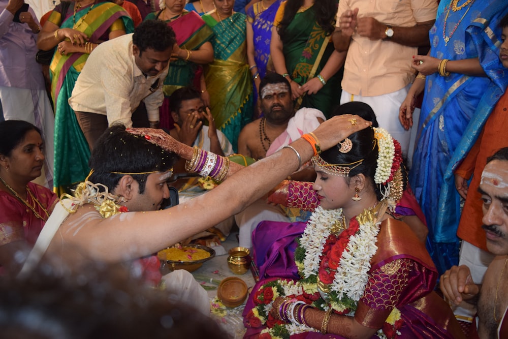 woman putting her hands on mans head