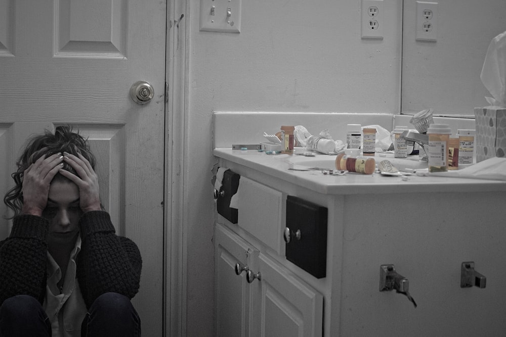 woman sitting in front of door