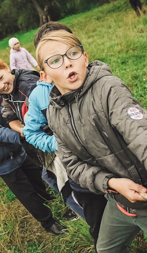 group of children pulling brown rope