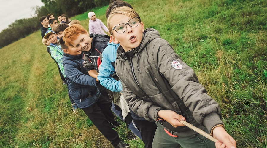 group of children pulling brown rope