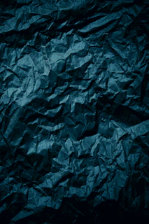 a dark blue crumpled paper background