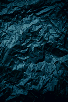 a dark blue crumpled paper background