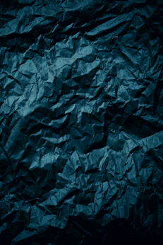 a dark blue crumpled paper background