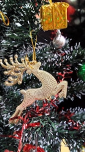 A festive card featuring a gold embossed reindeer with a textured finish.