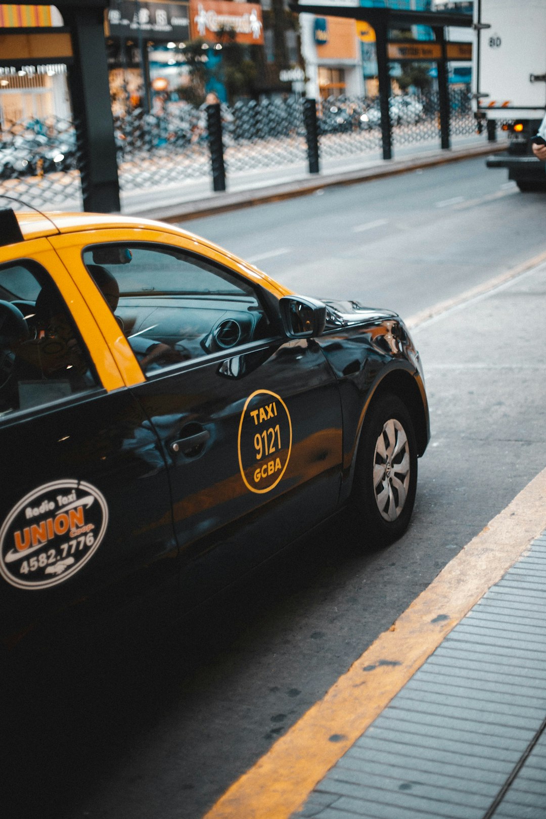 black Taxi on the road at daytime