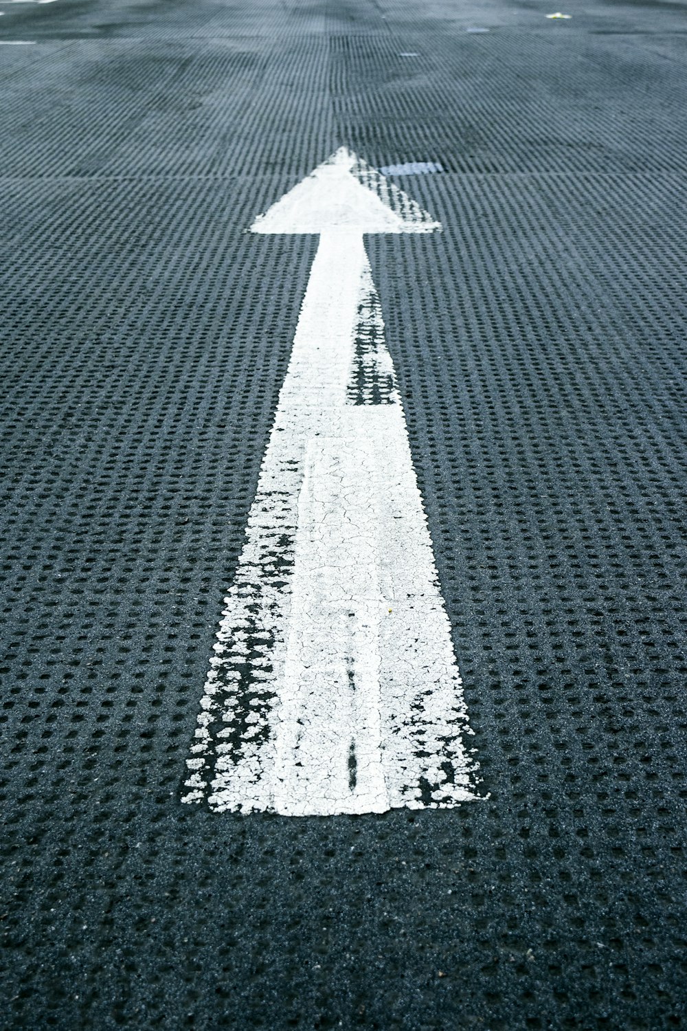 painted arrow sign on floor