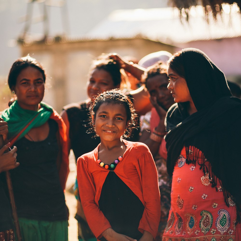 girl standing between group of women