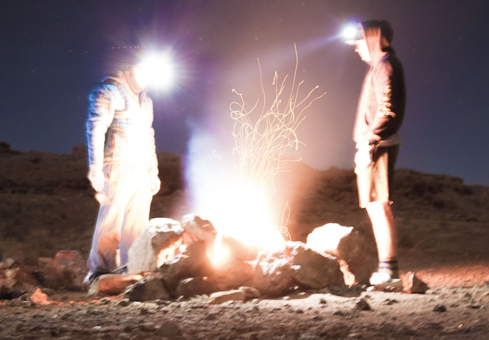 two men standing in front of rocks