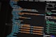 Developer comparing AI coding tool token costs on a laptop
