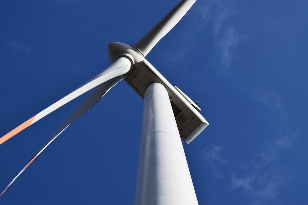 low angle photo of white metal windmill