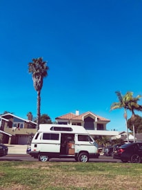 A clean, accessible medical transport van parked in front of a residential home.
