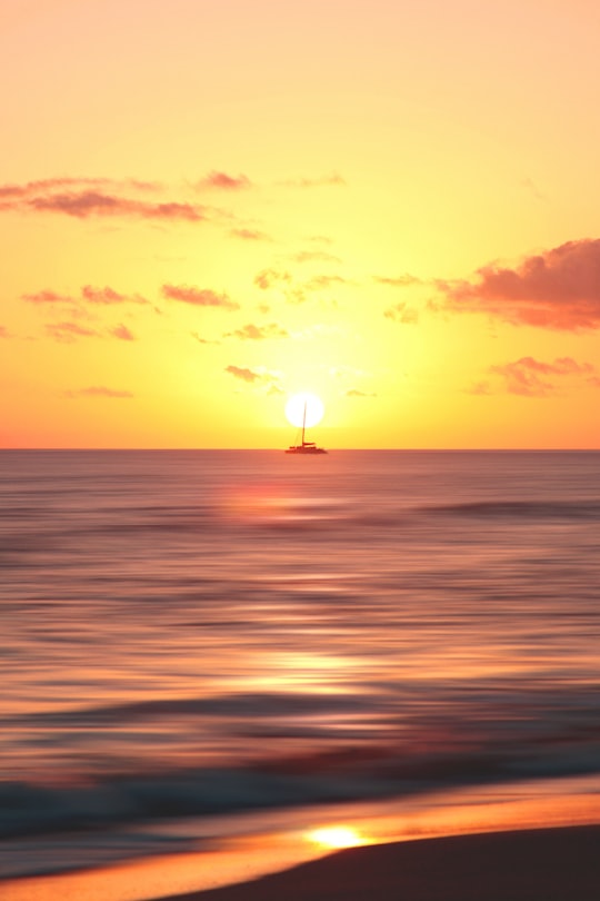 boat on body of water during sunset in Hawaii United States
