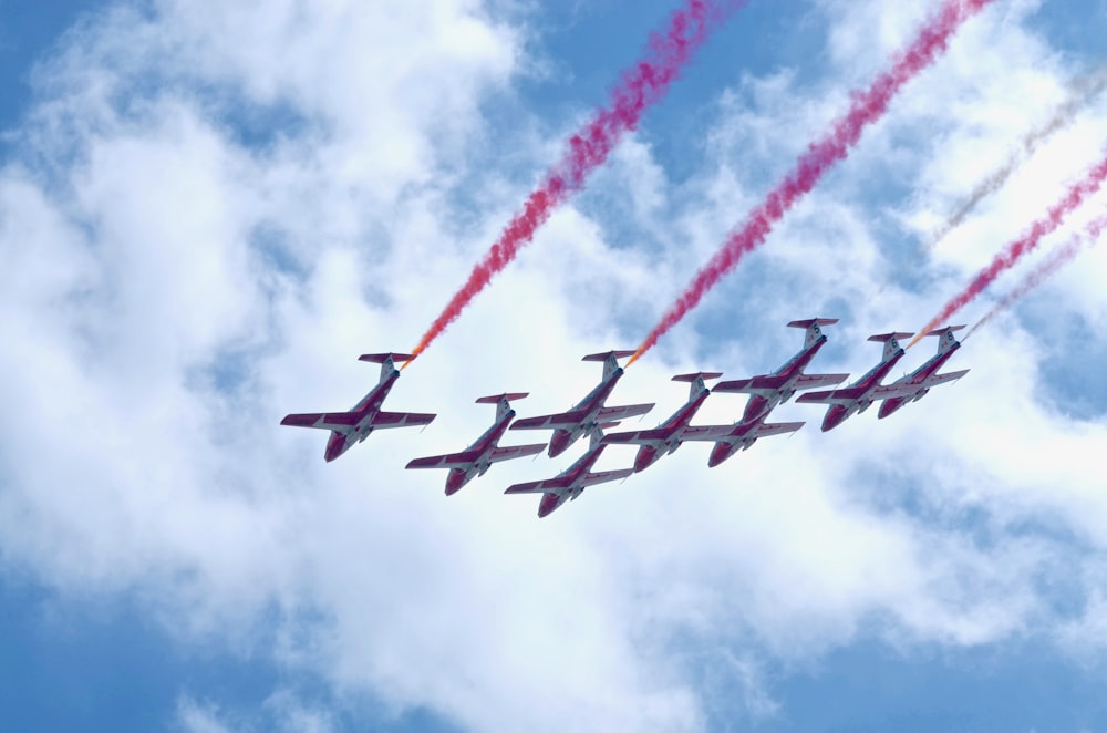 white-and-red planes in mid air