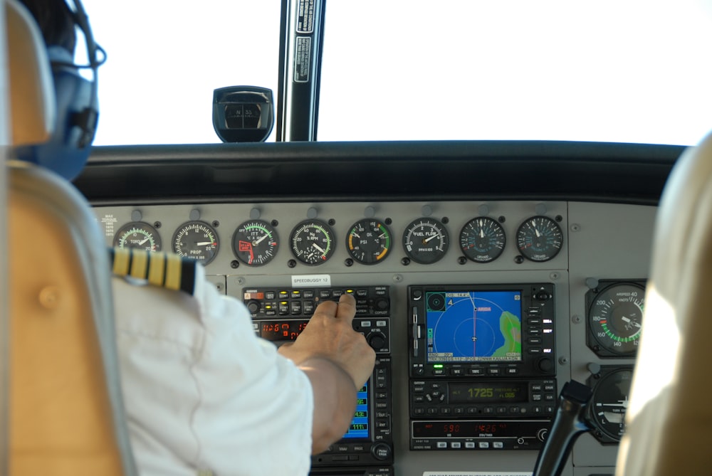 pilot controlling airplane dashboard