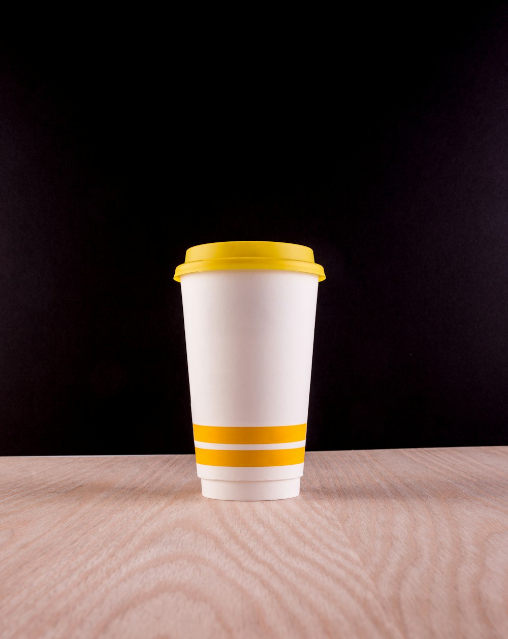 white and yellow plastic cup