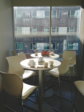 Image of a UK business registration certificate displayed with a British flag and a cup of tea on a desk.