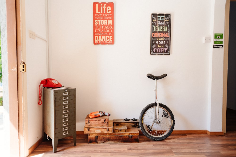 white and black unicycle behind the wall