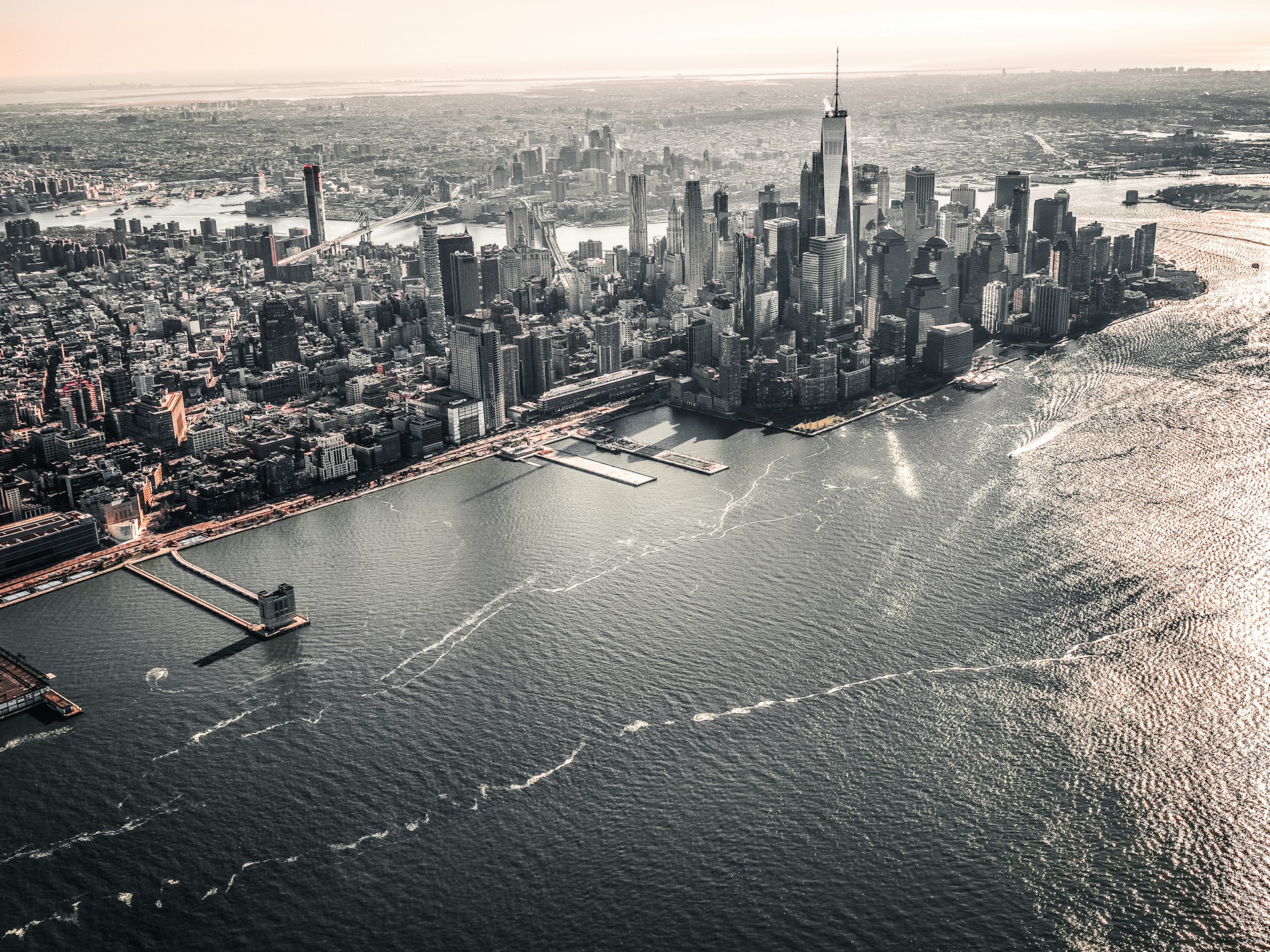 aerial photography of large body of water across city with high-rise buildings at daytime