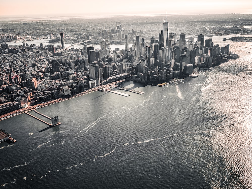 aerial photography of large body of water across city with high-rise buildings at daytime