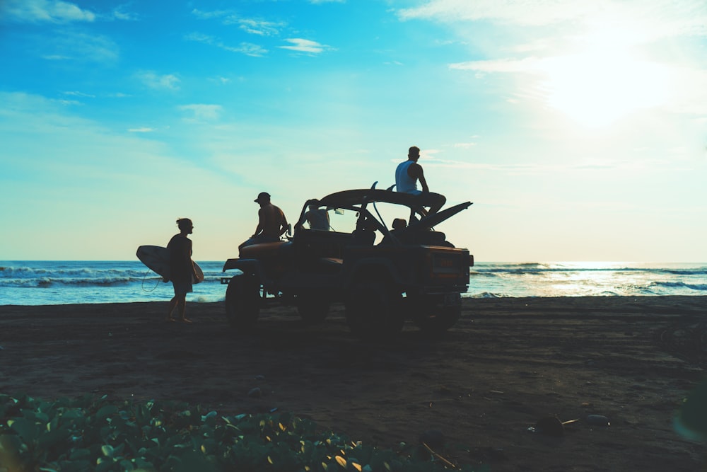 people inside truck near ocean