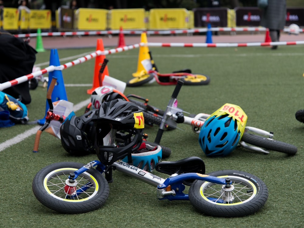 two gray lying bicycles on green grass field