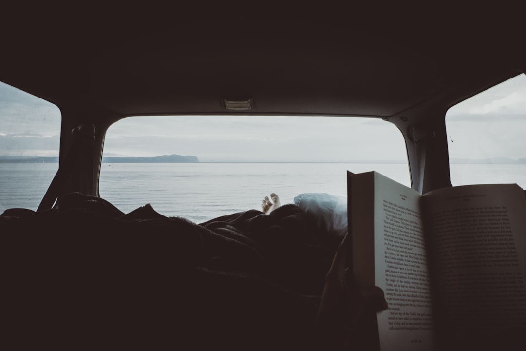 person reading book inside vehicle interior, Dear Lake Taupo,<p></figure>Thank you.