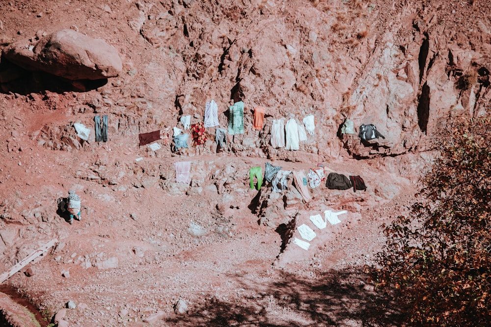 aerial photography of assorted-color clothes on rock formation