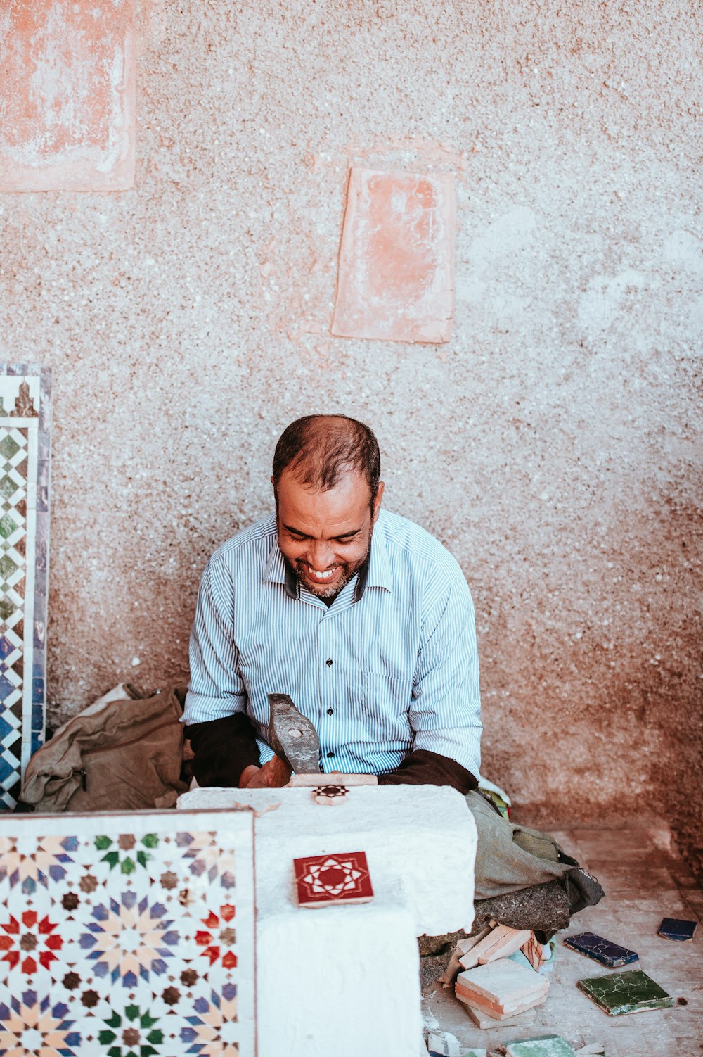 man smiling sitting on floor during daytime