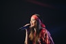 woman in red dress holding microphone