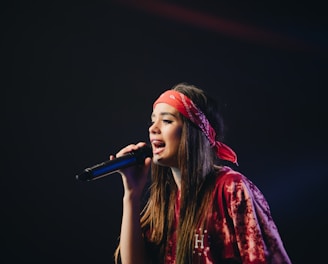 woman in red dress holding microphone