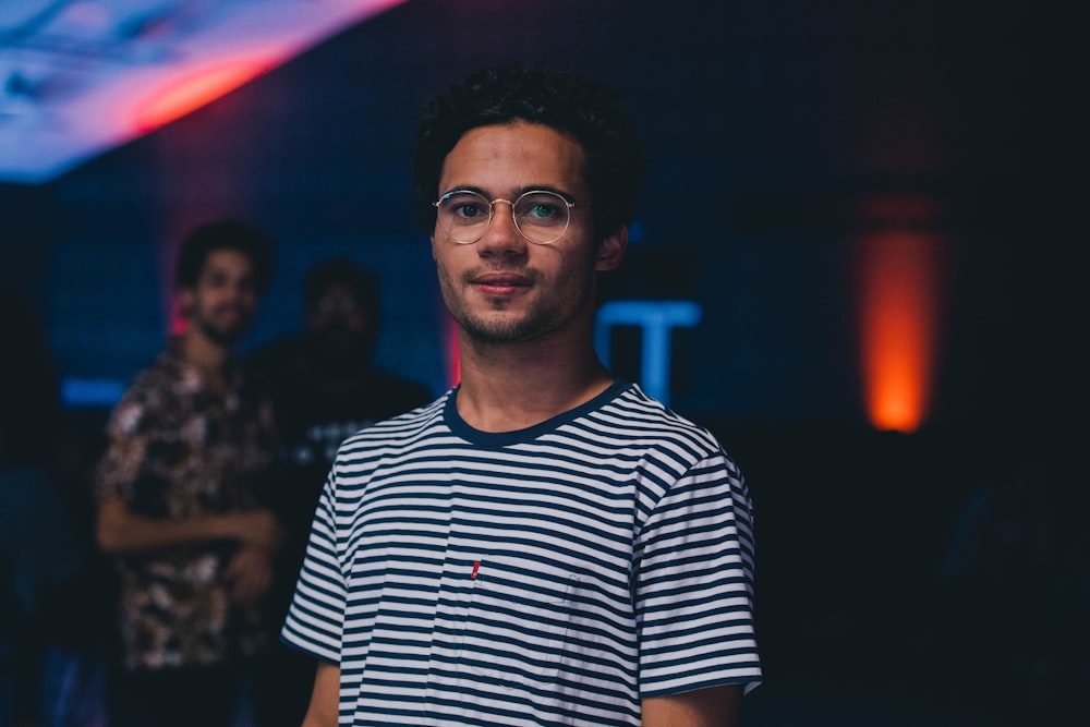 shallow focus photography of man wearing black and white striped crew-neck T-shirt