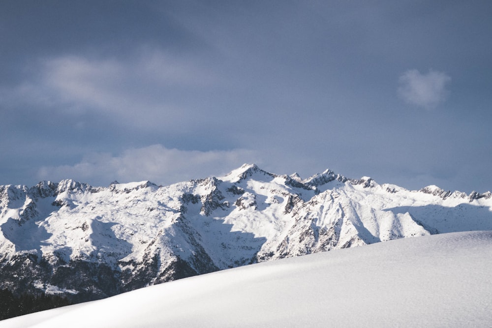 white and black mountain under blue and white sky at daytime