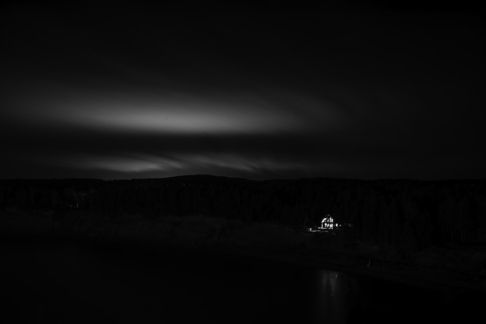 a black and white photo of a house in the dark