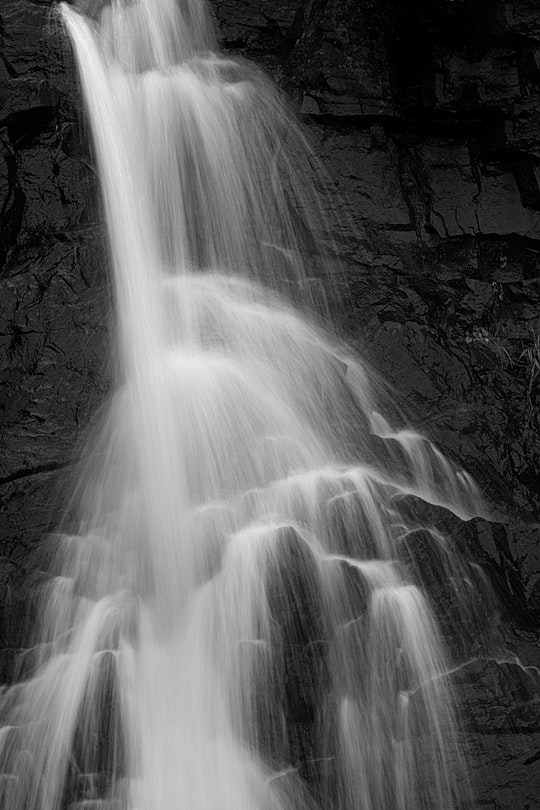 grayscale photo of waterfall in Newfoundland and Labrador Canada