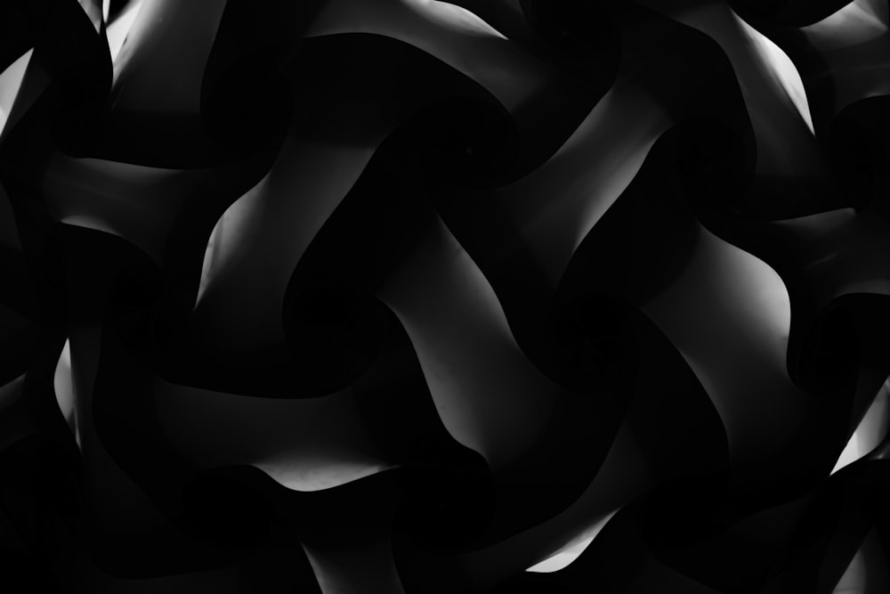 a black and white photo of a bunch of wavy shapes