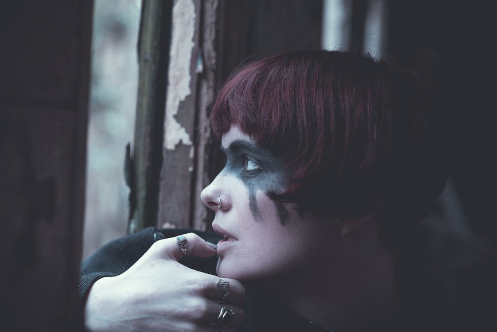 woman staring on window