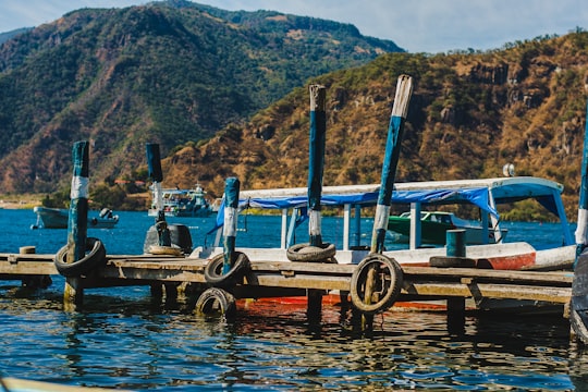 blue and white boat near dock in Panajachel Guatemala