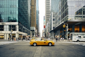 panning photography of tax between buildings