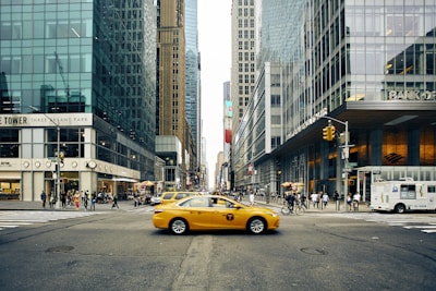 panning photography of tax between buildings
