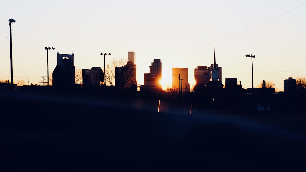 silhouette photo of city building during sunset