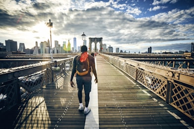 man walking on bridge