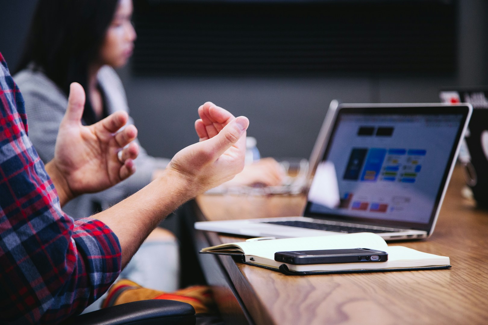 Photo of hands facing up while seated in front of a laptop