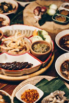 A vibrant spread of authentic Thai dishes showcasing green curry, fresh salads, and dipping sauces.