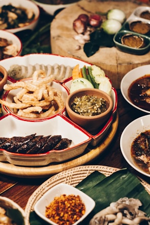 Assortment of Thai rice crackers neatly displayed on a wooden tray.