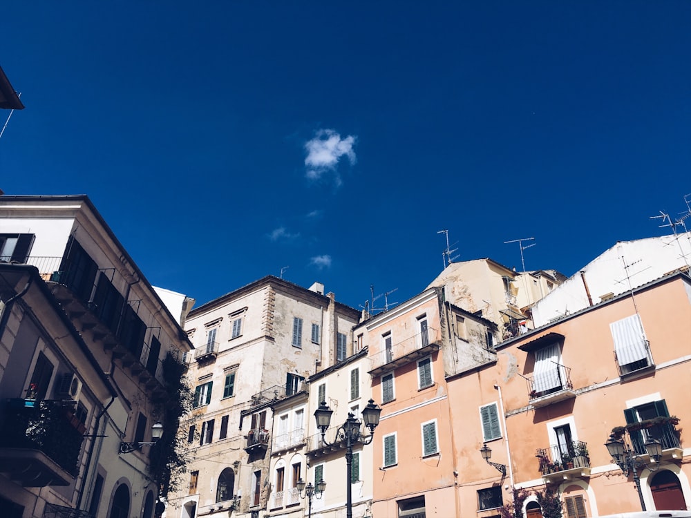 grey and orange buildings under blue sky