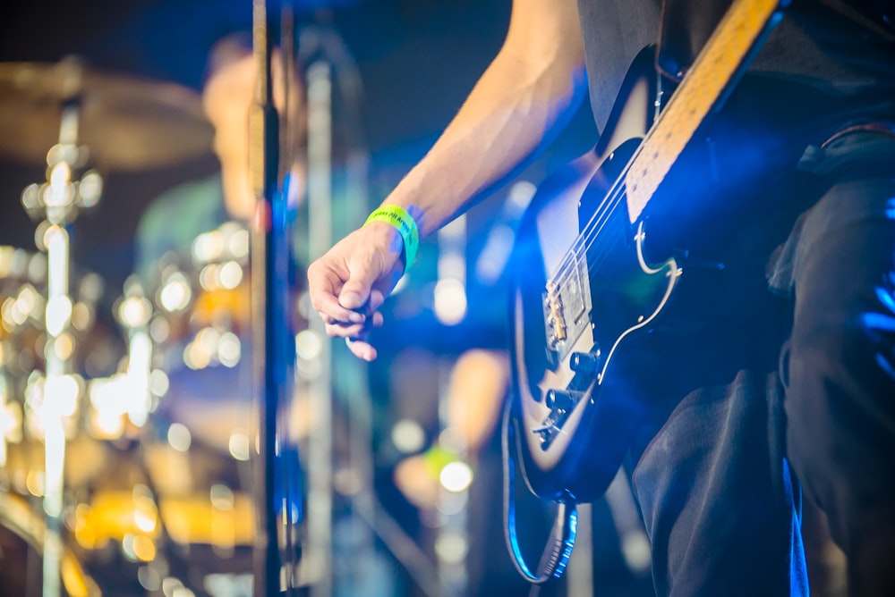 person playing black guitar