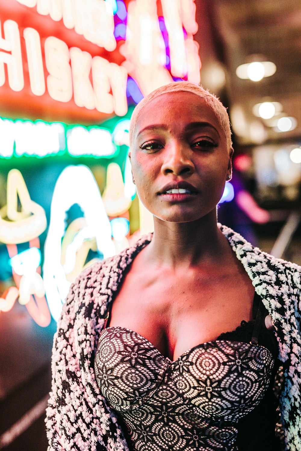 woman standing near neon light signage