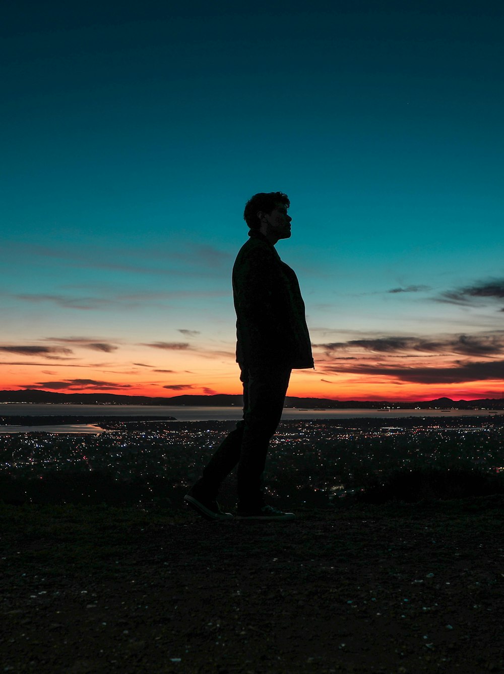 silhouette on man standing on seashore