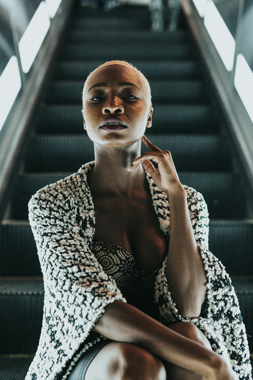 woman sitting on escalator