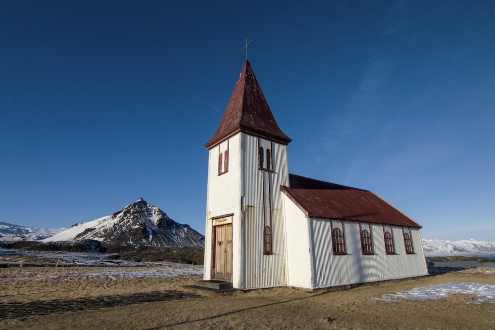 photo of white and brown concrete house near mountain